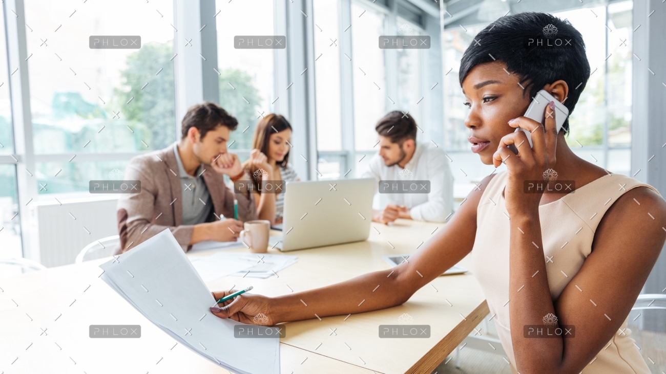 serious-businesswoman-with-documents-talking-on-P9Q6LX6