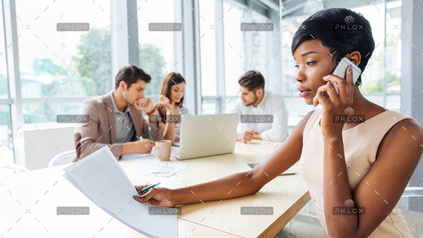 serious-businesswoman-with-documents-talking-on-P9Q6LX6