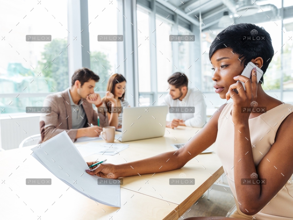 serious-businesswoman-with-documents-talking-on-P9Q6LX6